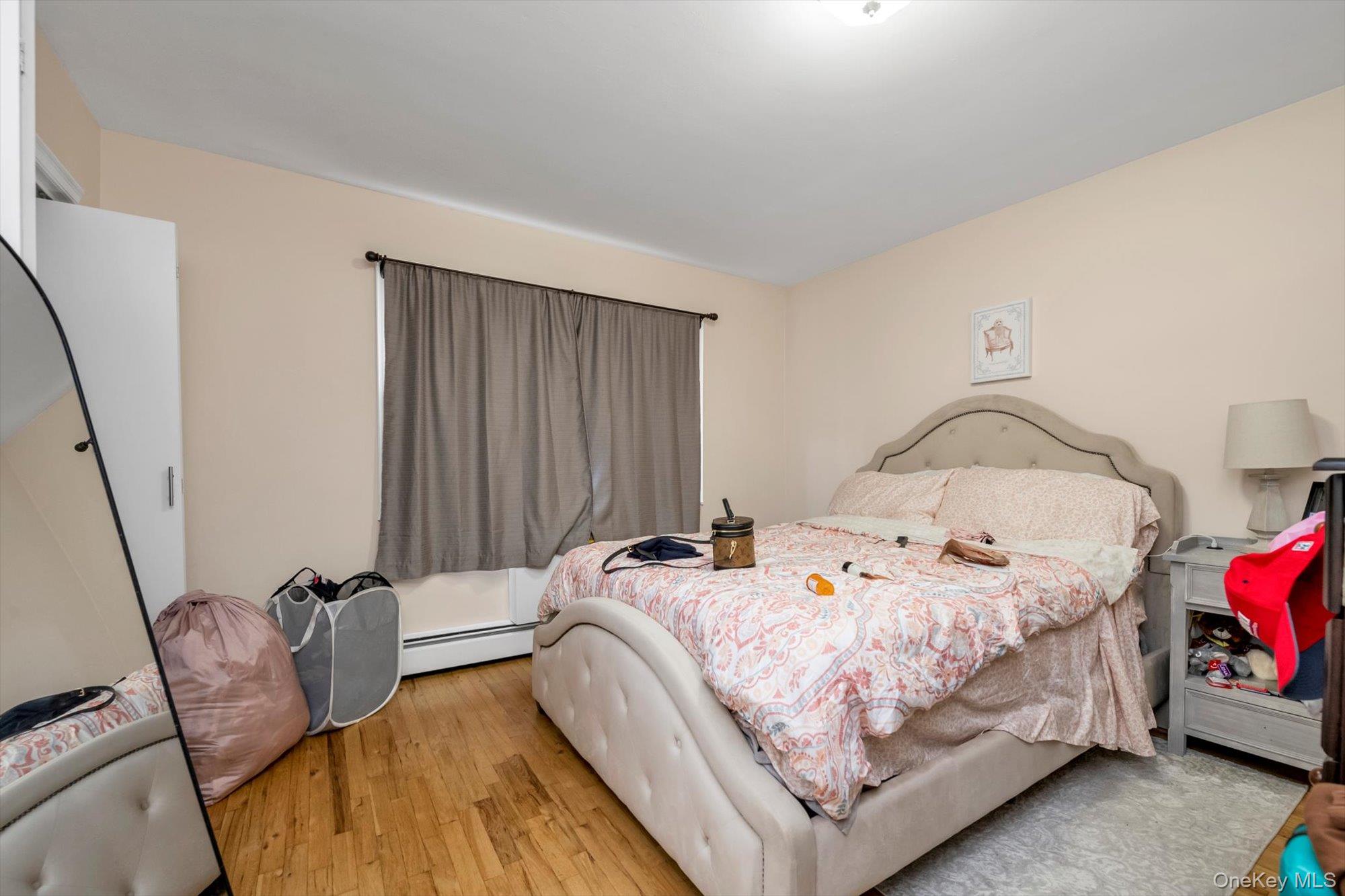 61-26 164th Street Queens, NY 11365 - Photo 8 of 17 a bedroom with bed and a window