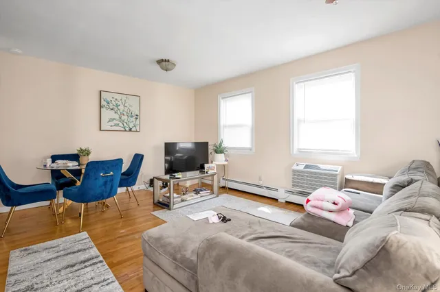 a bedroom with furniture and a flat screen tv