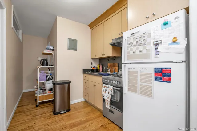 a kitchen with stainless steel appliances a refrigerator and a stove top oven