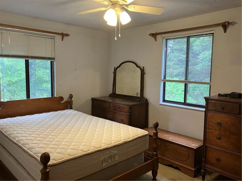 125 Beacon Road Renfrew, PA 16053 - Photo 24 of 31 a bed sitting in a bedroom next to a window