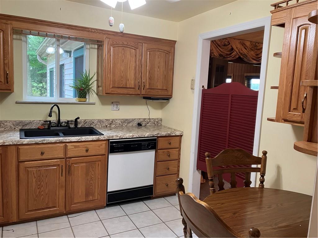 125 Beacon Road Renfrew, PA 16053 - Photo 5 of 31 a kitchen with granite countertop white cabinets and window