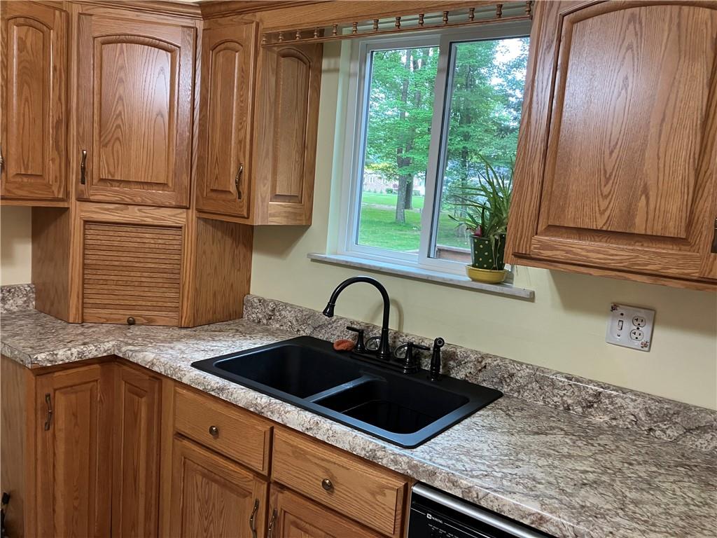125 Beacon Road Renfrew, PA 16053 - Photo 6 of 31 a kitchen with a sink stove and cabinets