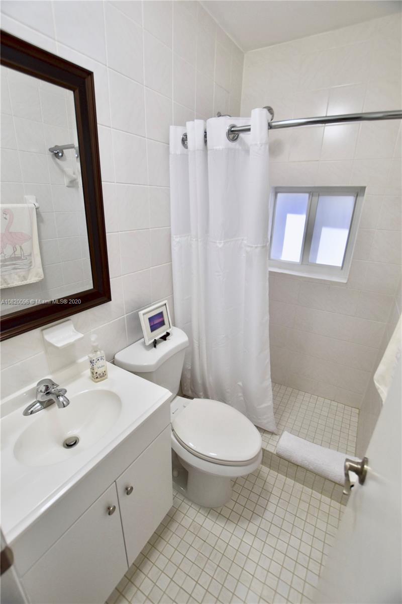 2270 Southwest 24th Street Miami, FL 33145 - Photo 15 of 22 a bathroom with a sink a toilet and a mirror