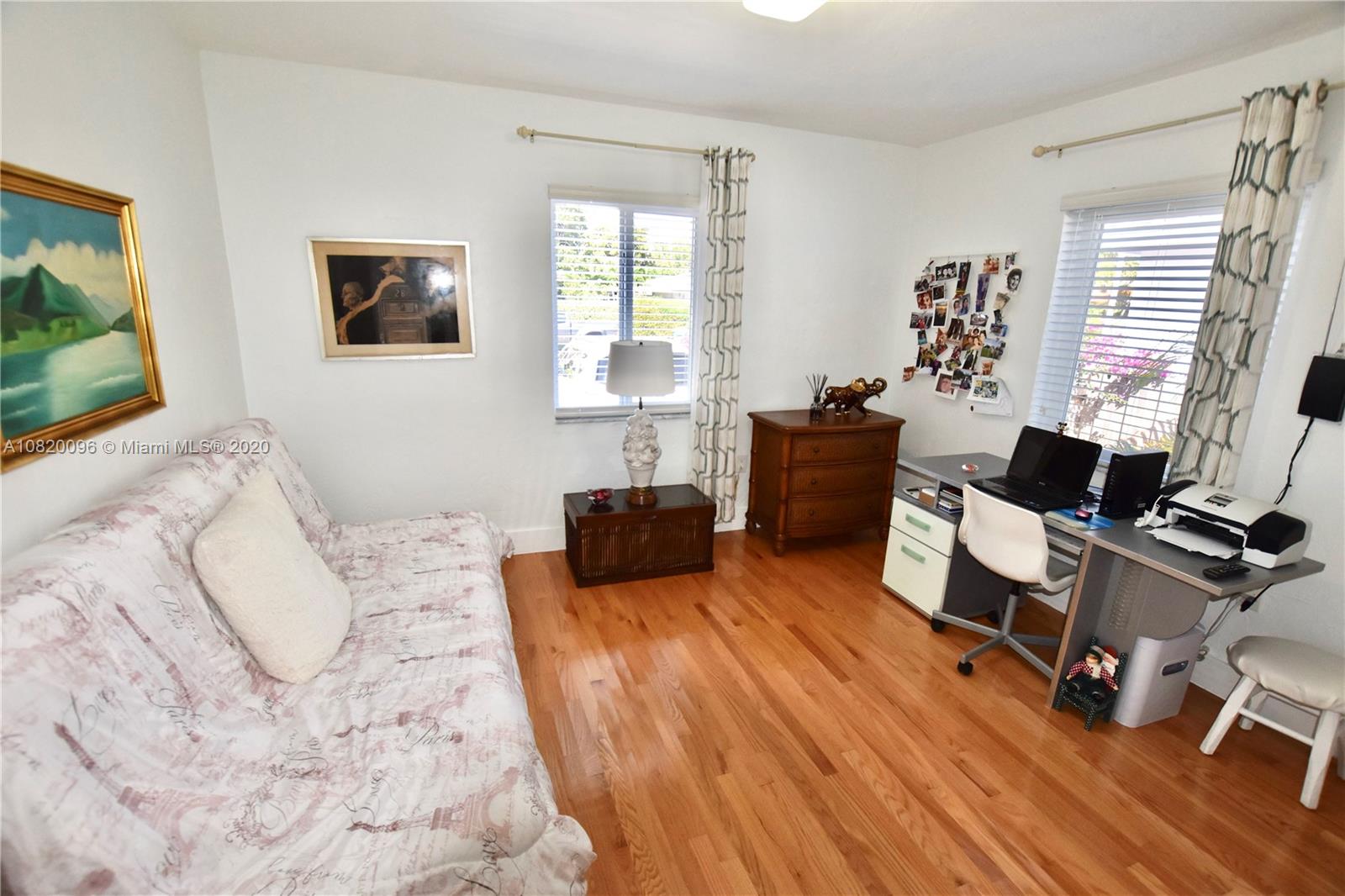 2270 Southwest 24th Street Miami, FL 33145 - Photo 17 of 22 a bedroom with a bed and a wooden floor