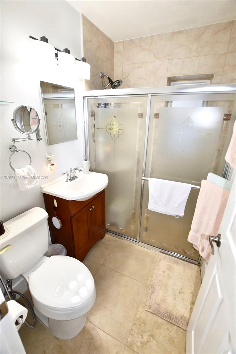2270 Southwest 24th Street Miami, FL 33145 - Photo 18 of 22 a bathroom with a toilet sink and mirror