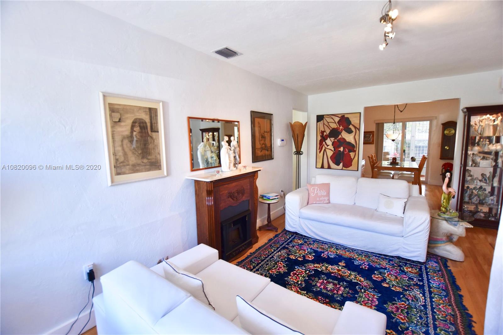 2270 Southwest 24th Street Miami, FL 33145 - Photo 4 of 22 a living room with furniture and a painting on the wall