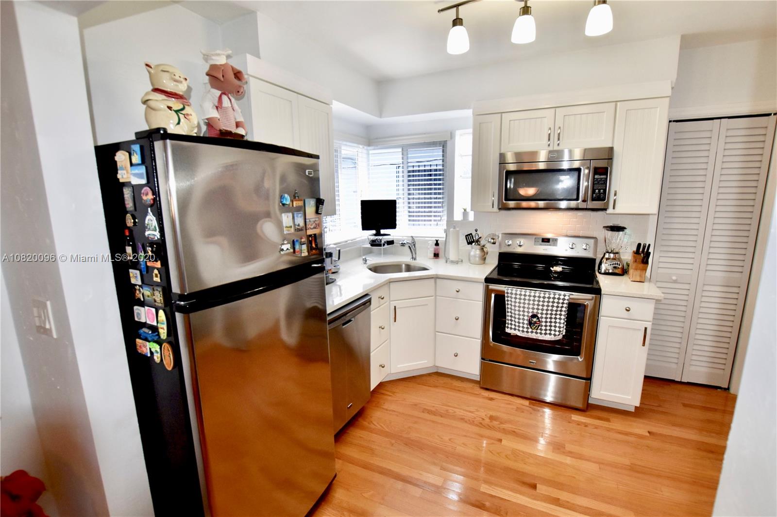 2270 Southwest 24th Street Miami, FL 33145 - Photo 8 of 22 a kitchen with stainless steel appliances a refrigerator stove and microwave