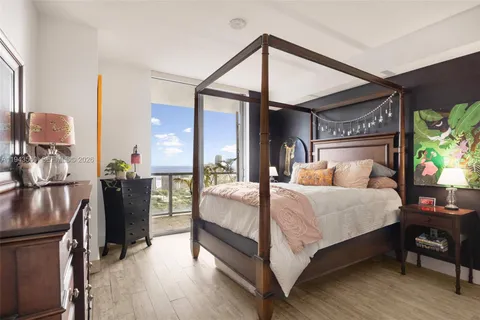 a bed room with a bed and a chandelier