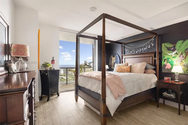 a bed room with a bed and a chandelier