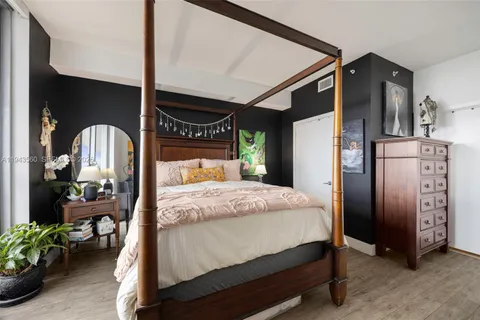 a bed room with a bed and a potted plant