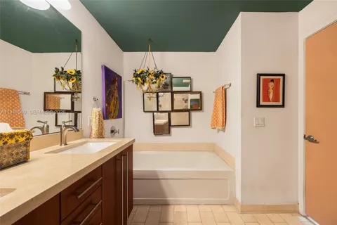 a bathroom with a sink mirror and a bathtub