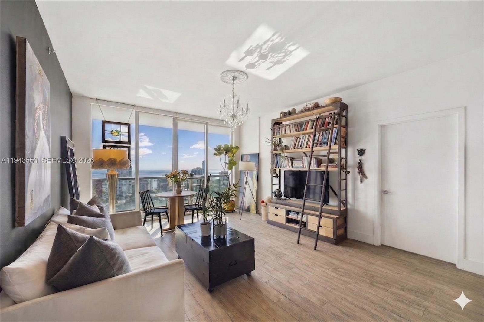 79 Southwest 12th Street, Unit PH3904S Miami, FL 33130 - Photo 2 of 33 a living room with furniture and a chandelier