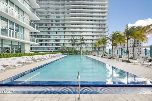 a view of swimming pool with outdoor seating