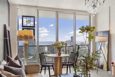 a dining room with furniture a livingroom and chandelier