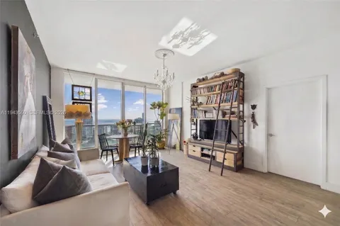 a living room with furniture and a chandelier