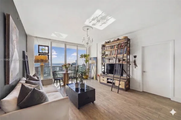 a living room with furniture and a chandelier