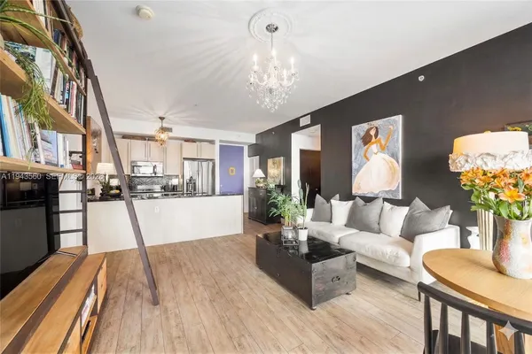a living room with furniture and a chandelier