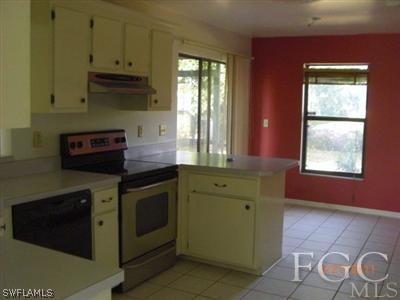 17536 Lebanon Road Fort Myers, FL 33967 - Photo 5 of 10 a kitchen with stainless steel appliances granite countertop a stove a sink and a microwave
