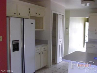 17536 Lebanon Road Fort Myers, FL 33967 - Photo 7 of 10 a room with a refrigerator and cabinets