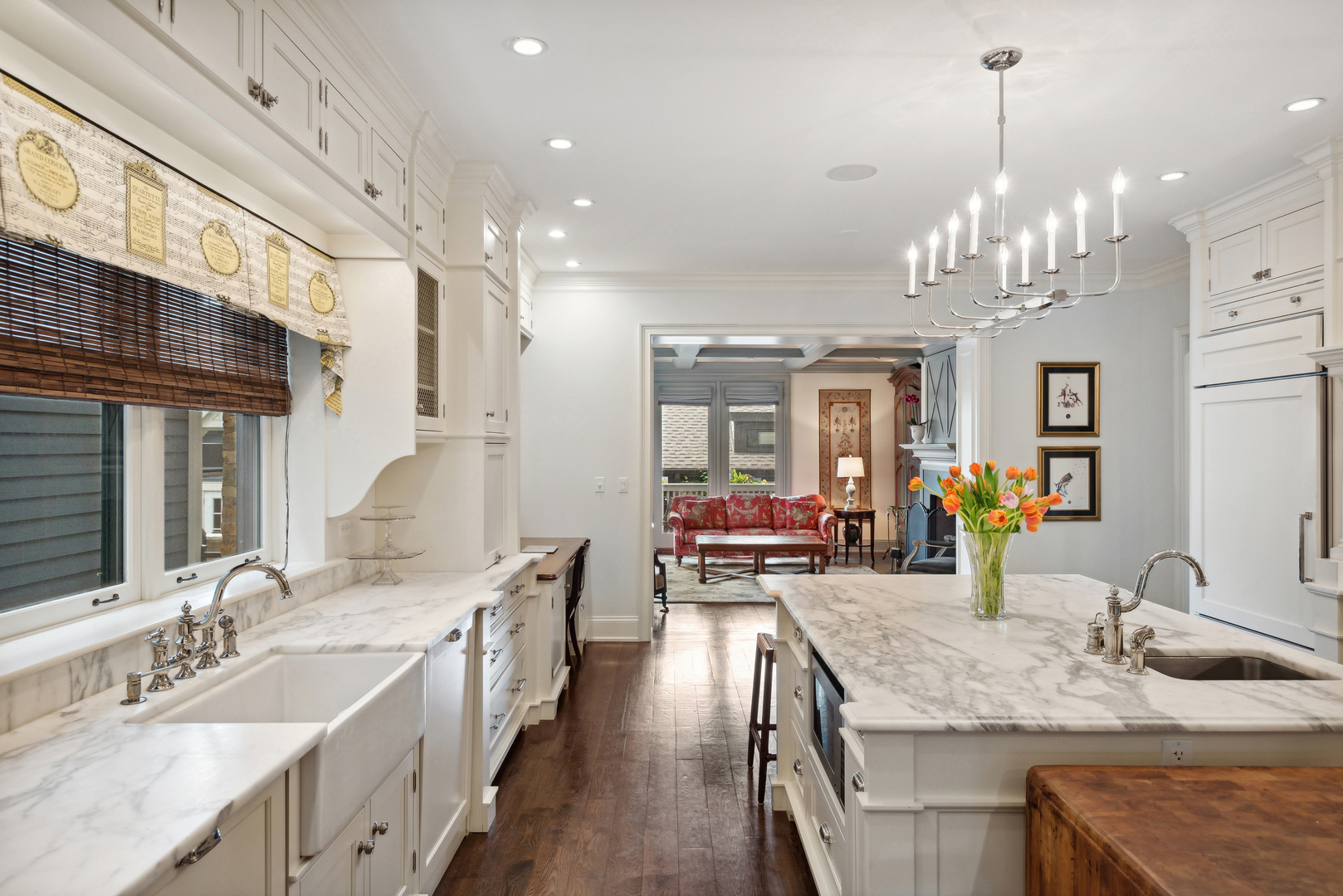 2148 West Giddings Street Chicago, IL 60625 - Photo 3 of 51 a bathroom with double vanity sinks a granite counter top a sink and a chandelier