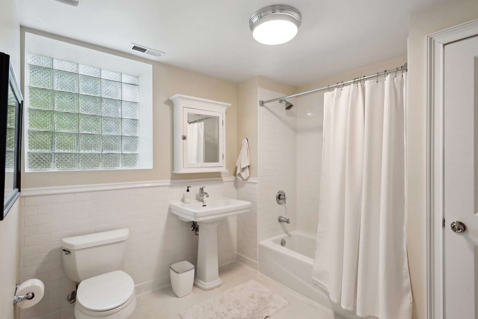2148 West Giddings Street Chicago, IL 60625 - Photo 44 of 51 a bathroom with a sink toilet and shower