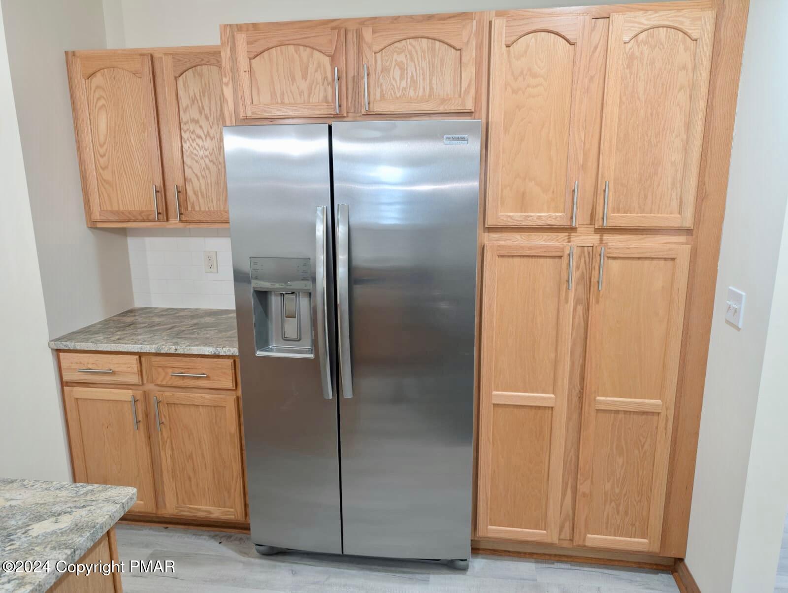 143 Cornwall Place Bushkill, PA 18324 - Photo 10 of 34 a kitchen with metallic refrigerator freezer and a dishwasher