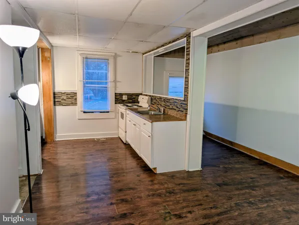 a kitchen with granite countertop a stove and a refrigerator
