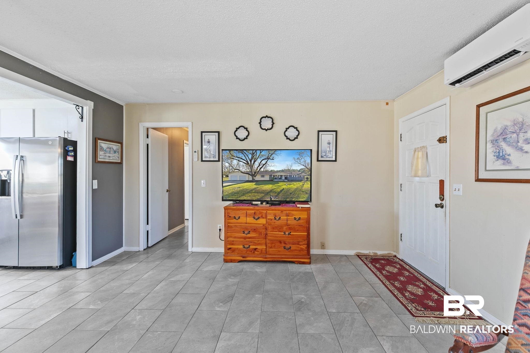21267 Loop Road Andalusia, AL 36421 - Photo 18 of 72 Living area featuring a wall mounted AC and baseboards
