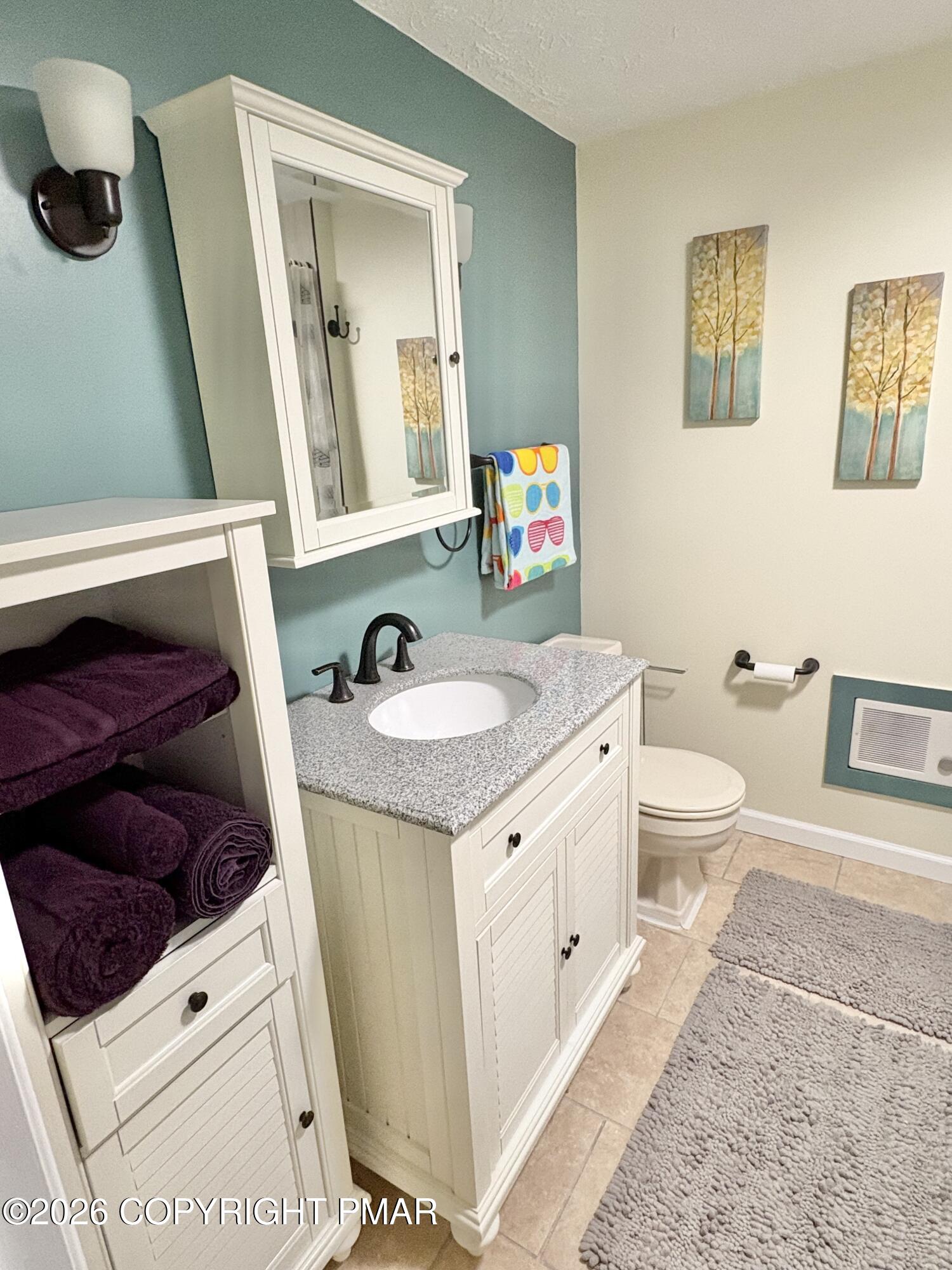 481 Moseywood Road Lake Harmony, PA 18624 - Photo 11 of 20 a bathroom with a toilet sink and mirror