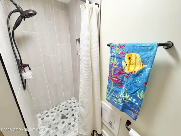 a bathroom with a door and a shower