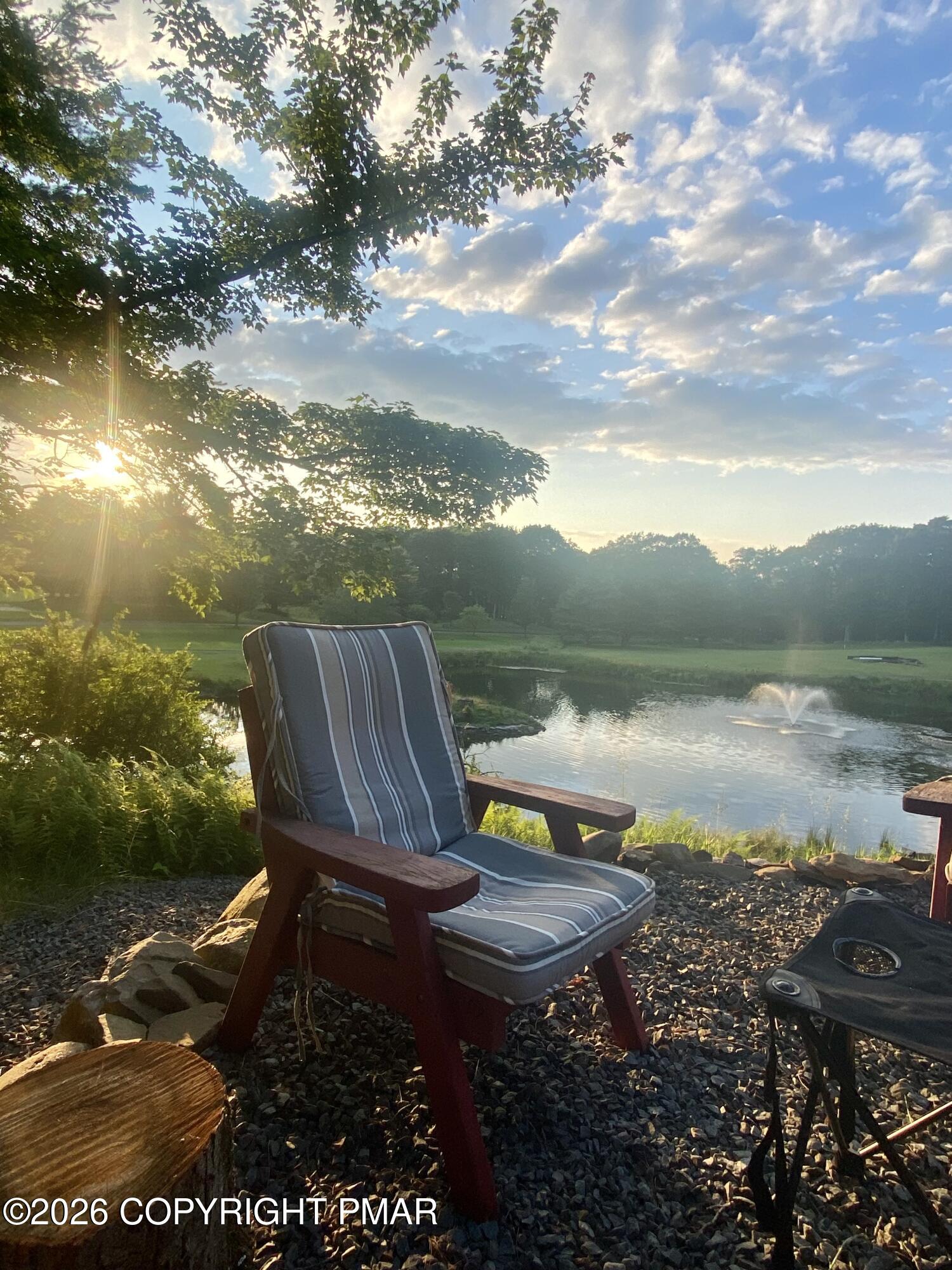 481 Moseywood Road Lake Harmony, PA 18624 - Photo 2 of 20 a view of a lake with lawn chairs and a table