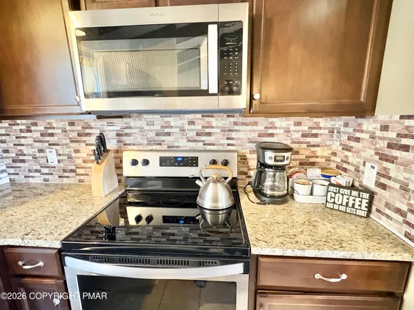 a stove top oven sitting inside of a kitchen