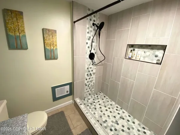 a bathroom with a sink toilet and shower