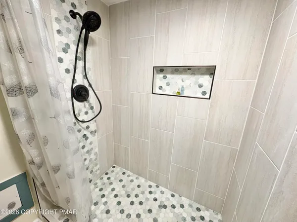 a bathroom with a shower and a sink