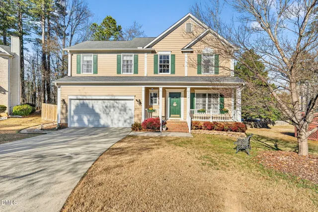 a view of a house with a patio and a yard