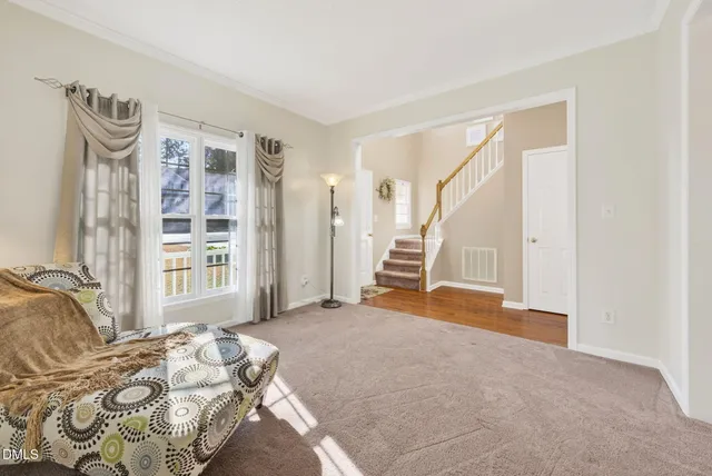 a dining room with furniture a chandelier and window