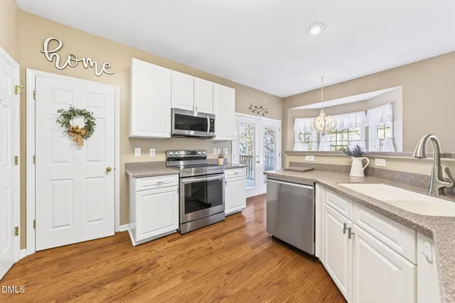 a spacious bedroom with a bed and a dresser