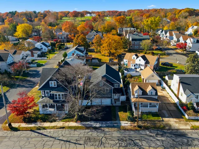 a view of a house with a swimming pool and a yard