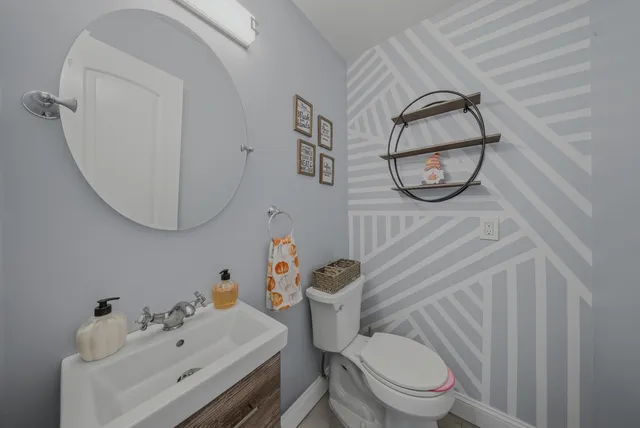 a white toilet sitting next to a bathroom sink