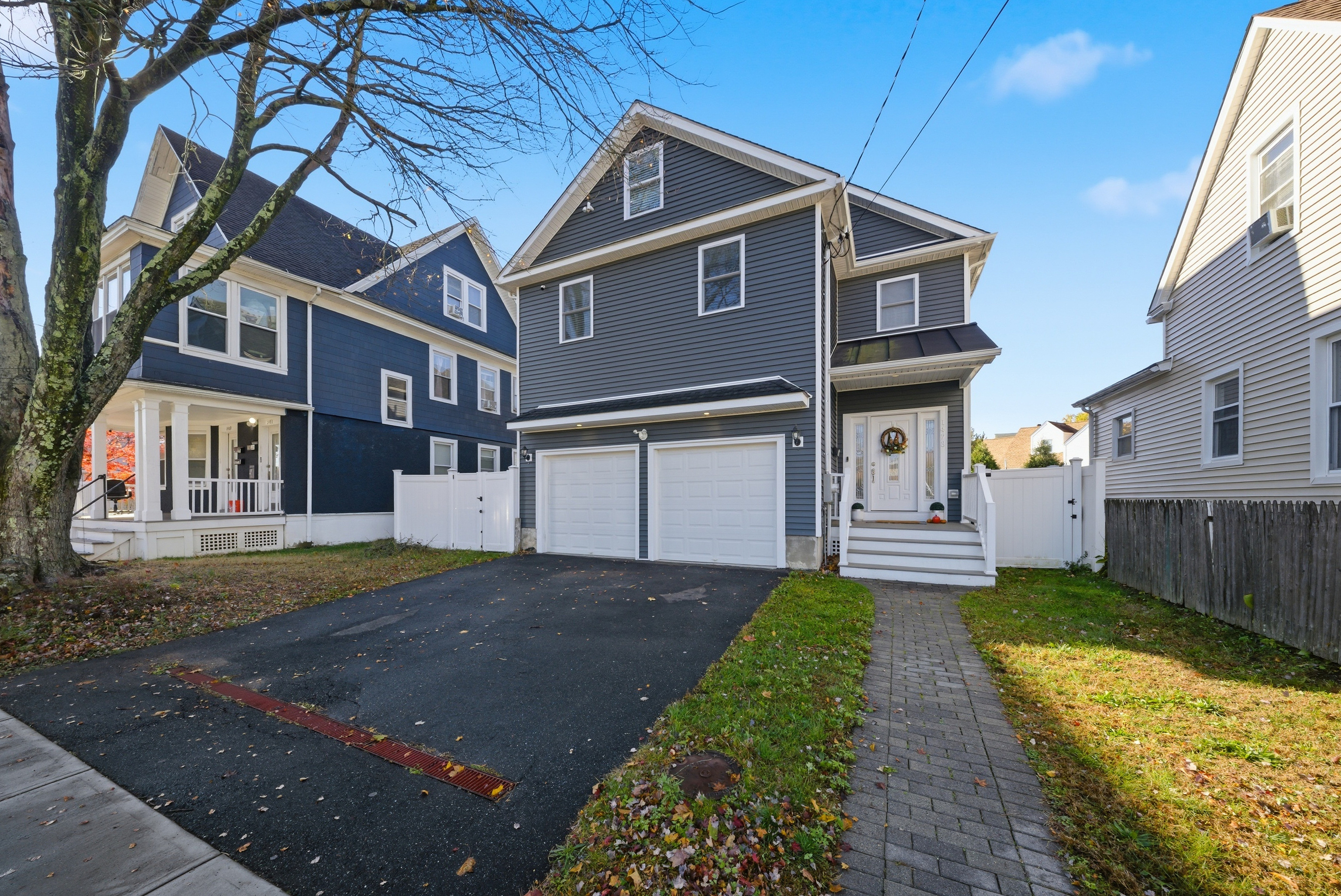 1473 Wood Avenue Bridgeport, CT 06604 - Photo 3 of 40 a front view of a house with a yard and garage