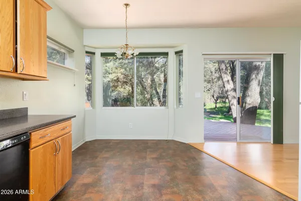 a kitchen with a refrigerator a stove top oven and cabinets