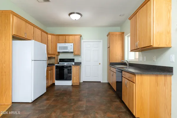 a kitchen with a refrigerator a stove top oven a sink and dishwasher