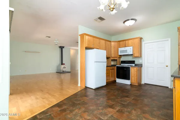 a kitchen with refrigerator a stove a microwave and cabinets