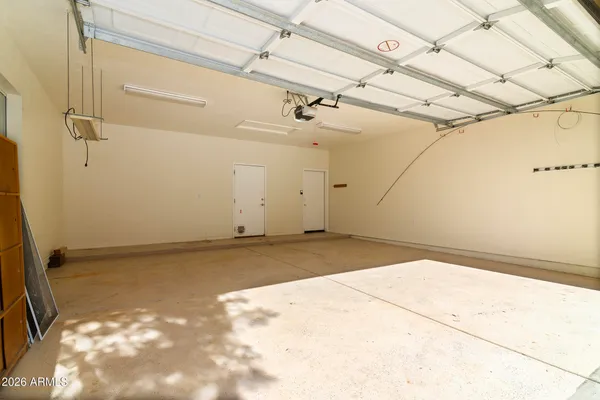 an empty room with a ceiling fan and windows