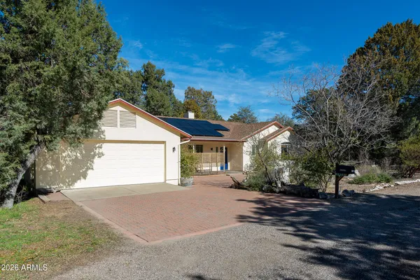a view of a house with a yard and garage