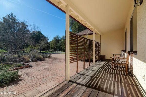 a view of balcony with wooden floor and fence