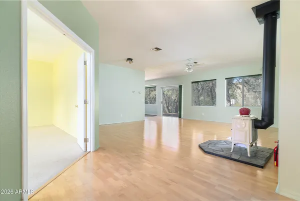 a view of a livingroom with furniture wooden floor and a fireplace