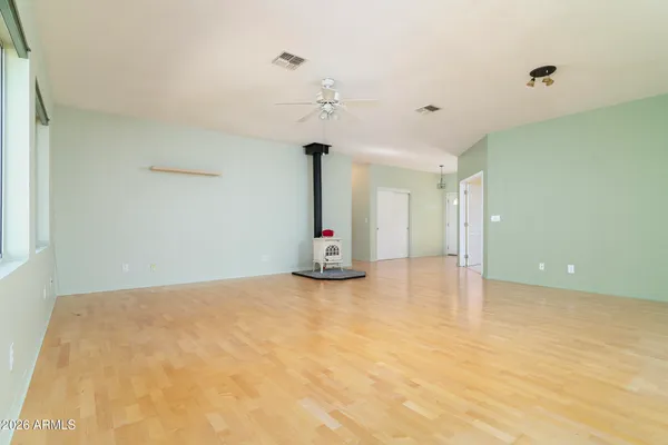 a living room with furniture flat screen tv and a large window