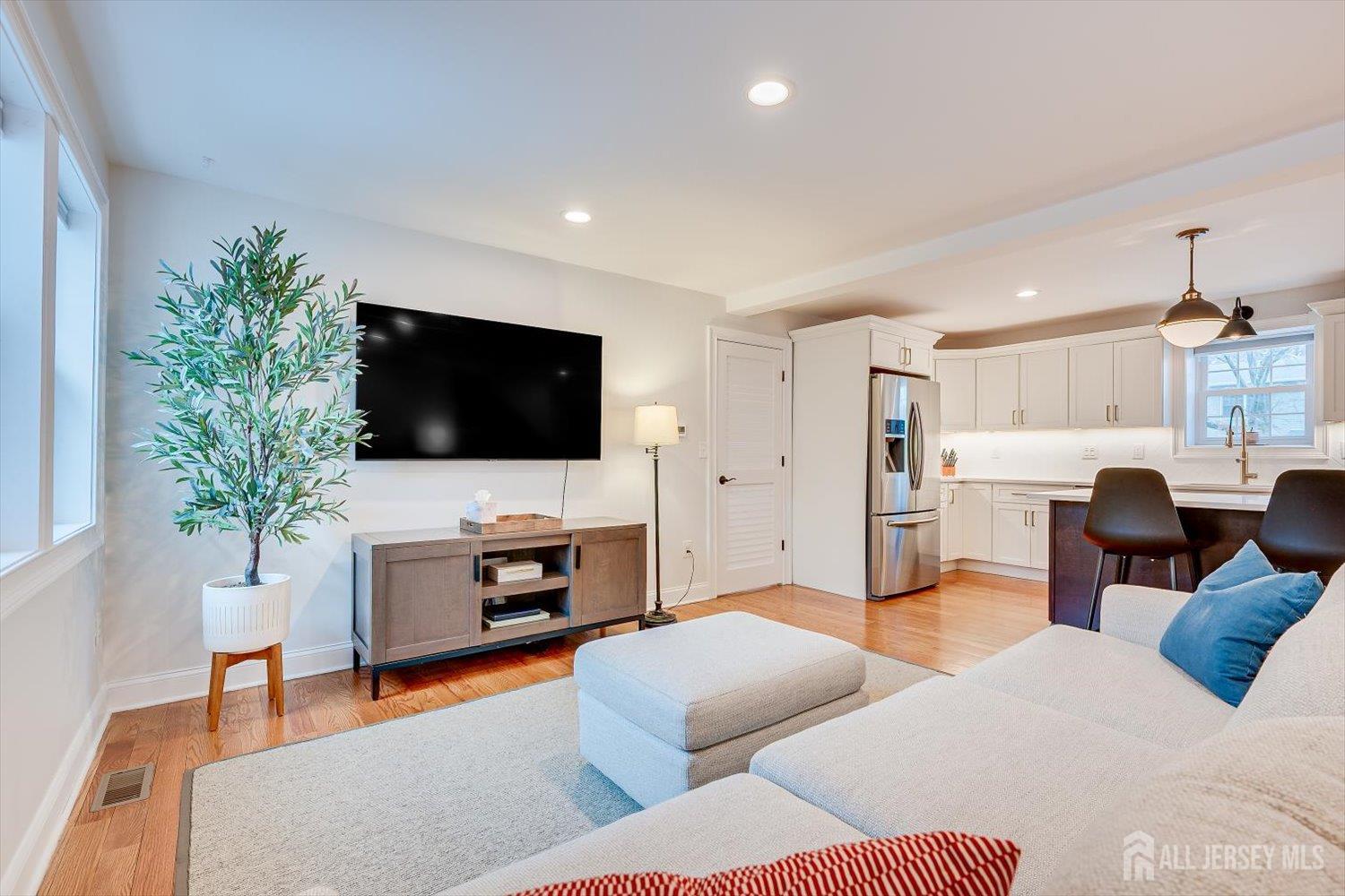 152 4th Street Edison, NJ 08837 - Photo 8 of 37 a living room with furniture and a flat screen tv