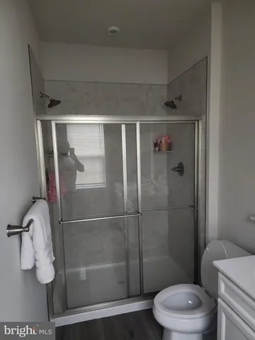 a bathroom with a toilet and a shower
